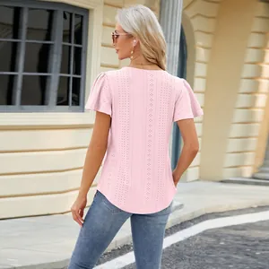 Detailed back view of a pink eyelet lace short sleeve top with a stylish curved hem