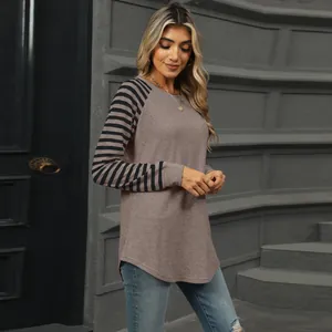 Detailed view of stylish women's color-block striped patchwork t-shirt with curved hem.