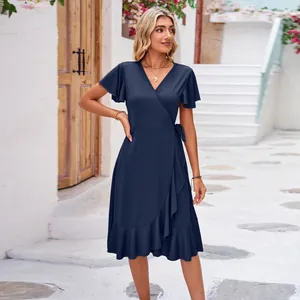 Detailed view of a navy blue V-neck wrap dress with ruffle sleeves and hemline