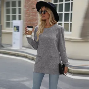 A lifestyle detail of the grey ribbed long sleeve top featuring stylish puff sleeves.