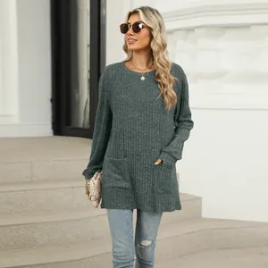 Detail view of casual loose round neck ribbed top with functional pockets in grey green.