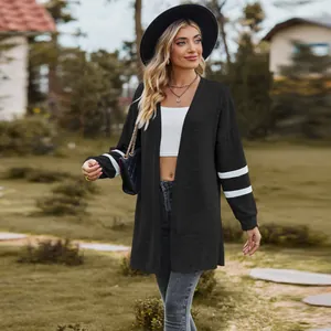 Fashionable black long sleeve knit cardigan with white stripe detail on sleeves outdoor