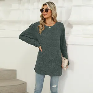 Stylish gray long sleeve knit top with puff sleeves and pockets worn by a model