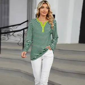Close-up of green and white striped V-neck top with lime green contrast trim