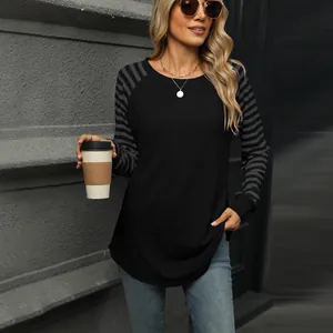 Detail of women's black long sleeve T-shirt featuring grey and black striped sleeves