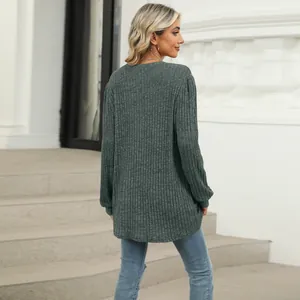 Back view of a woman wearing a dark green ribbed top with bubble sleeves