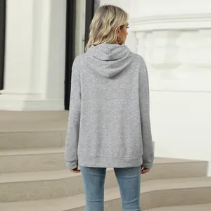 Back view of a casual grey solid color hooded sweatshirt for women with a relaxed fit