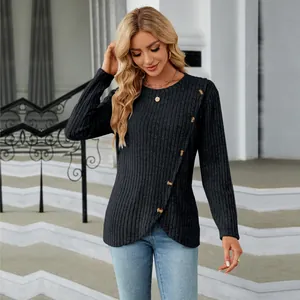 Detail view of ribbed long sleeve top with tulip hem and diagonal button accents.