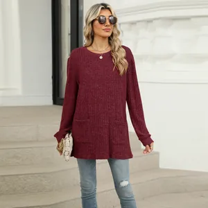 Casual women's burgundy knit top featuring a round neck and functional side pockets