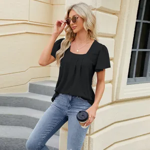Detail view of a stylish black square-neck top with pleated texture and short sleeves.