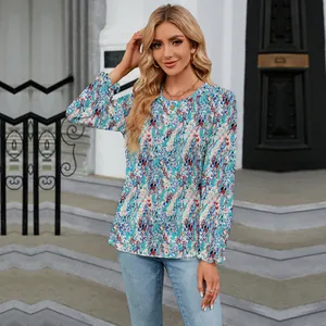 Model wearing a blue floral print round-neck long-sleeved loose-fit blouse outdoors
