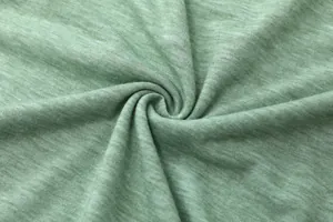 Close-up van zachte gemêleerde lichtgroene jersey stof voor casual dames T-shirt