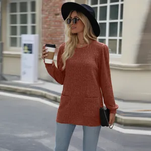 Burnt orange ribbed knit long sleeve tunic with front pockets and puff sleeves