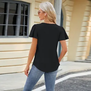 Back view of black eyelet jacquard short sleeve t-shirt in urban street setting