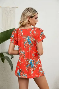 Detail of the back view on a red floral print top with double ruffle sleeves and loose fit