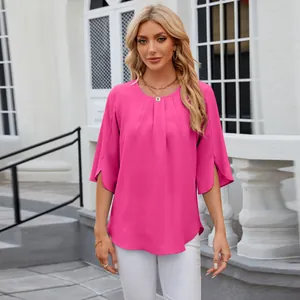 Detail view of a loose magenta chiffon blouse with round neck and split five-sleeves