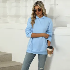 Casual light blue women's hooded sweatshirt with kangaroo pocket shown in outdoor setting