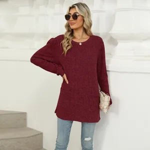 Detail of burgundy ribbed long-sleeve top with bubble sleeves and functional pockets