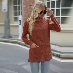 Elegant long-sleeve terracotta ribbed knit top with front pockets and classic crew neck