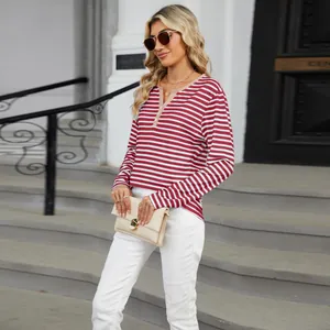 Outdoor lifestyle shot of a red and white striped V-neck long-sleeve T-shirt top