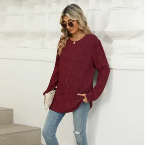 Close-up of wine red long-sleeved top with round neck and practical side pockets