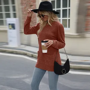 Street style view of terracotta ribbed long sleeve top with puff sleeves and pockets