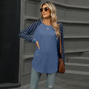 Detail view of women's long sleeve T-shirt with blue striped sleeves and curved hem.