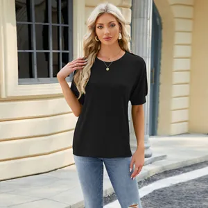 Detail showing a black raglan sleeve round neck t-shirt on a model outdoors