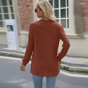 Back view of women's rust-brown ribbed long sleeve top with puff sleeves and casual fit.