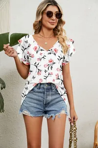 Detail view showing floral pattern and double ruffle sleeves on white V-neck casual top
