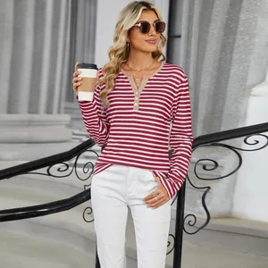 Detail shot of a women's red and white striped long sleeve T-shirt with a buttoned V-neck.