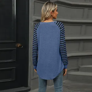 Back view of women's long sleeve top with striped sleeves and curved swallowtail hem