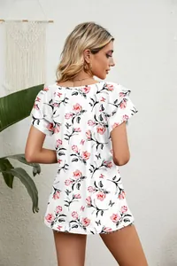 Detailed back view of a white floral T-shirt featuring double-layer ruffle sleeves.
