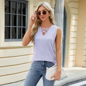 Detail view of lavender sleeveless top with V-neck criss-cross strap and jacquard fabric.