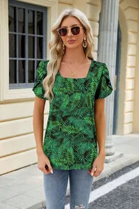 Detail of women's square neck top featuring vibrant leaf print and petal sleeves.