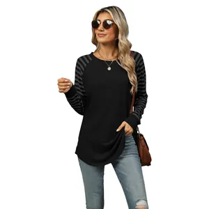 Stylish women's long sleeve T-shirt with colorblock striped raglan sleeves.