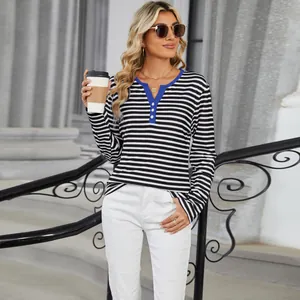 Outdoor street style shot of women's striped long sleeve T-shirt with blue V-neck