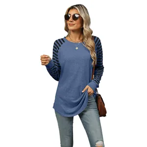 Women's blue crew neck long sleeve T-shirt with black striped raglan sleeves and high-low hem.