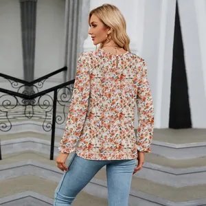 Detailed back view of a casual floral print blouse with a round neck and long sleeves