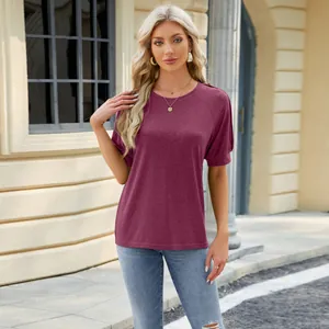 Detailed view of burgundy raglan sleeve t-shirt with chic button accents and round neck