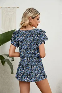 Back view detail of a bohemian blue floral print top featuring layered ruffle sleeves