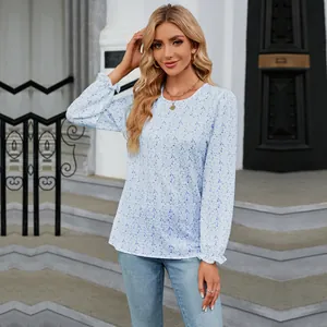 Detailed view of a casual blue floral long-sleeve blouse featuring a crew neck and relaxed fit.