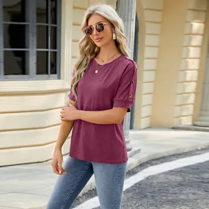 Detail view of women's burgundy raglan sleeve T-shirt with button decoration