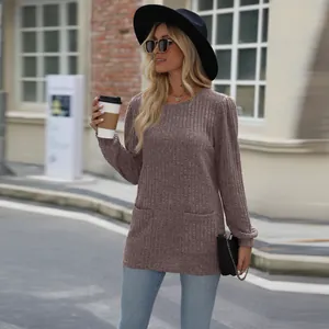 Detail view of women's casual loose mauve ribbed knit top with pockets and puff sleeves