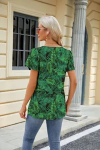 Back view of women's loose green tropical leaf print T-shirt with petal sleeves