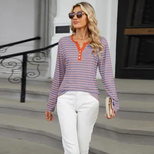 Casual long-sleeve striped t-shirt with contrast V-neck shown on a model outdoors.