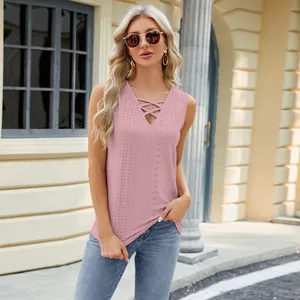 Close-up of pink jacquard sleeveless top with V-neck and criss-cross strap detail