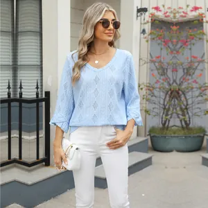 Detail of light blue V-neck t-shirt with diamond hollow-out jacquard and bell sleeves