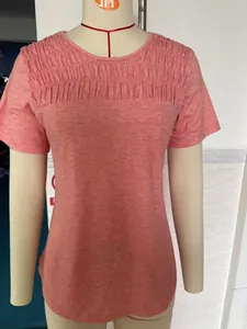 Detailed view of coral short sleeve T-shirt with elegant smocking and round neckline