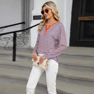 Stylish model in striped V-neck long sleeve tee with contrast trim and white pants